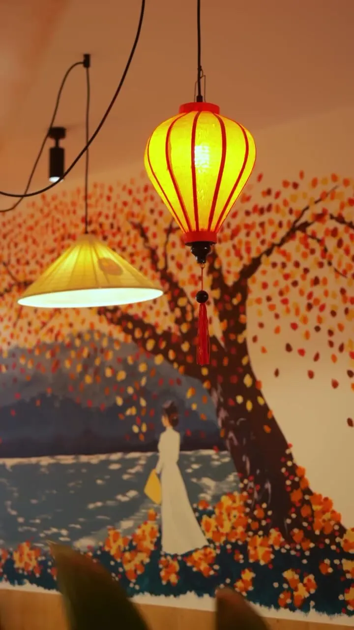 Lanterne devant la fresque de l’arbre aux feuilles rouges